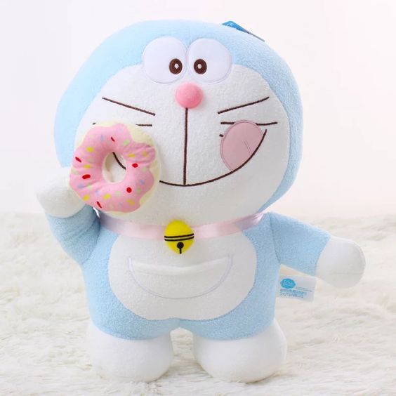 wallpaper boneka doraemon lucu makan kue